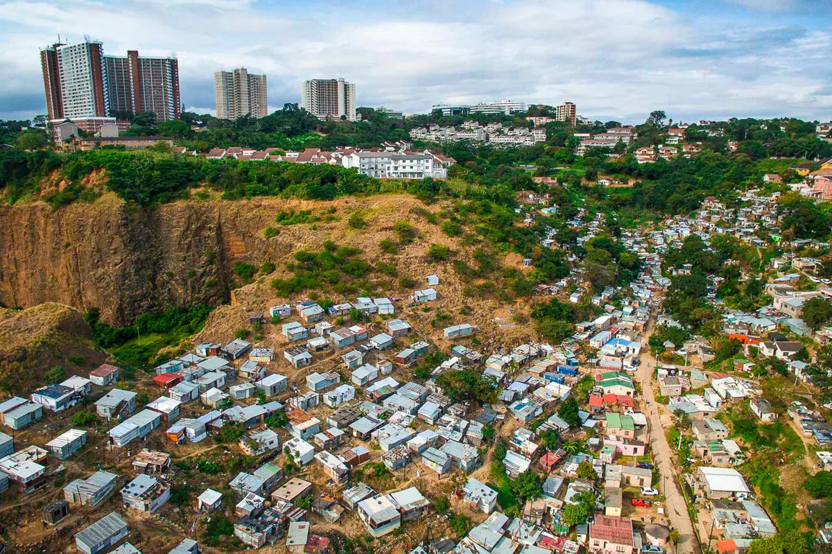 Một thị trấn nhỏ ở Durban, Nam Phi đang phải chống chọi với nguy cơ sạt lở và cuộc sống khó khăn trong khi trước mặt họ là những tòa nhà chọc trời. Ảnh: Johnny Miller