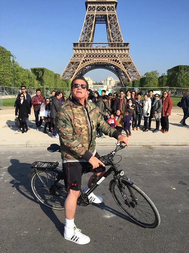 NEWS COPY Arnold Schwarzenegger terminated these tourists group photo - when he photobombed them in front of the EIFFEL TOWER. The group of families from Thailand had been on holiday in the French capital when they stopped for a souvenir shot at the landmark on Sunday. But they were stunned when a rude foreigner stopped in front of the carefully composed holiday snap. Only moments later after the tour guide had snapped him making a cheeky pose did they realise it was Schwarzenegger, star of the Terminator movies. Tourist Lek Wattana, 32, who was part of the group, said: ''We all went to Paris on a group tour and we all got together for a picture in front of the Eiffel Tower. ''Then some foreigner on a bike stopped in front of the group. I was thinking to myself why is he so rude?. He blocked the view of the group picture. ''After we finished the tour guide they said wow, hold on, its Arnold Schwarzenegger. Everybody was shocked, we went crazy and called him back but he had already rode away. ''There were five or six bodyguards on a bike with him and one on a motorcycle. I wanted to scream because we saw the Hollywood star. Arnold - former California governor - mentioned the group on his Instagram page when he said: ''Fantastic bike ride through Paris. I cannot say this enough: to truly appreciate a city, get on a bike. Thank you to the tourists at the Eiffel Tower for letting me crash your photo!'' ENDS